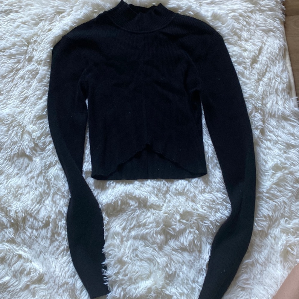 ribbed soft black long sleeve with a mock neck and V cut in the front.